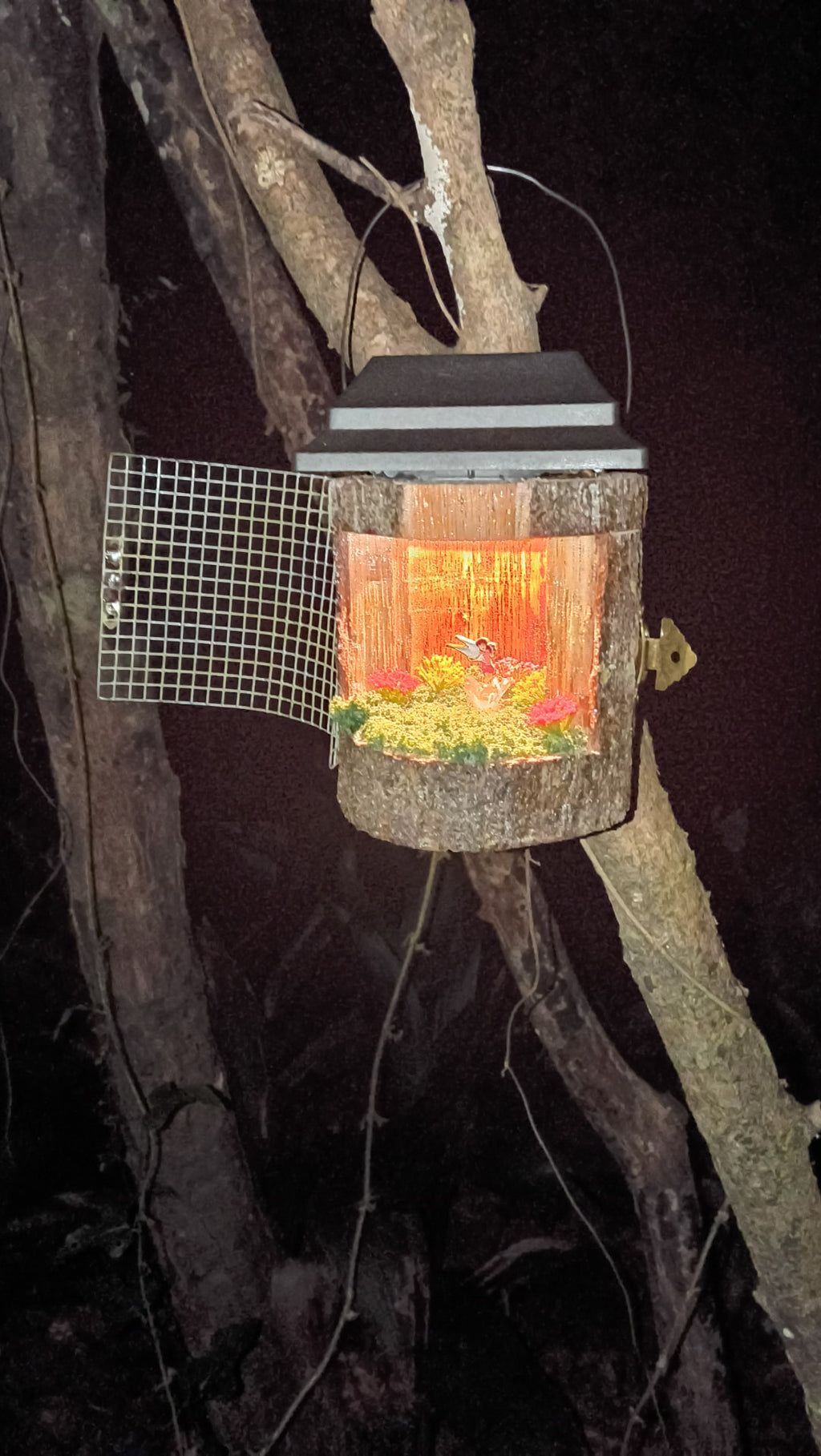 Guardian Fairy Lamp glowing at night hanging in a tree