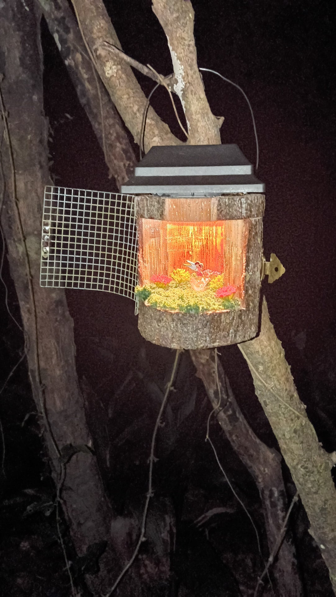 Guardian Fairy Lamp glowing at night hanging in a tree